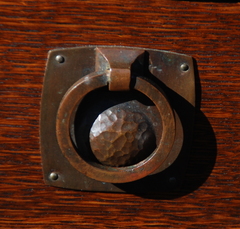 Detail early style hand hammered drawer pull.